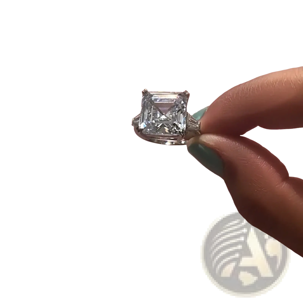 Asscher cut lab diamond sterling silver promise ring with a sparkling emerald cut diamond held between fingers