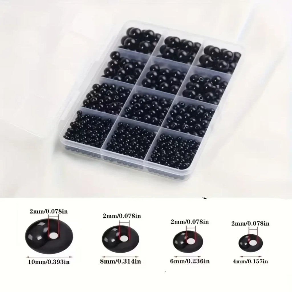 Assorted round black plastic bead set in a clear compartmentalized organizer for diy jewelry making in multiple sizes