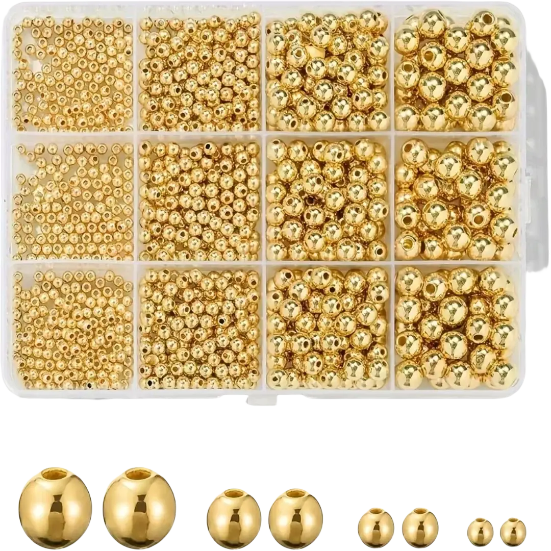 A clear plastic organizer box with assorted gold-colored round metal beads for diy jewelry making