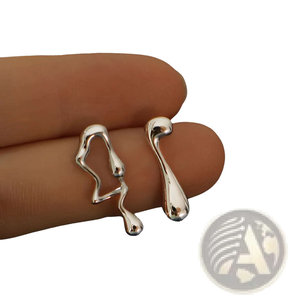 Asymmetric liquid silver lava stud earrings featuring silver abstract shapes with a liquid-metallic finish and flowing contours