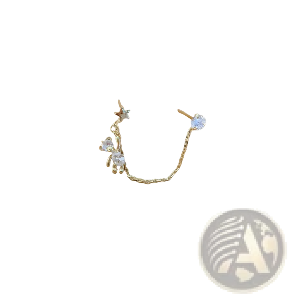 Gold-toned asymmetrical rhinestone bear and star tassel ear cuff featuring a tiny bear charm and clear crystals connected by a chain