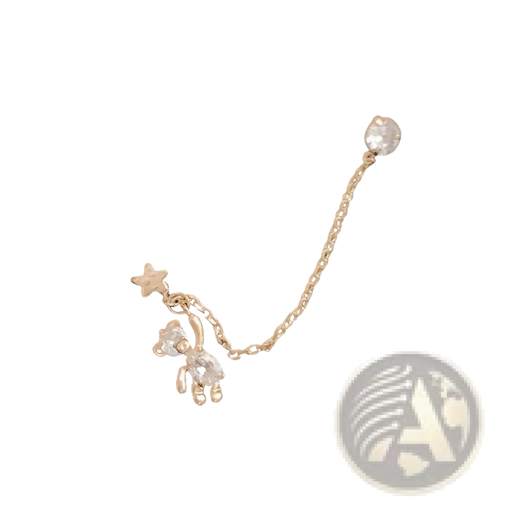 Gold-toned asymmetrical ear cuff with rhinestone teddy bear charm, star accent, and adjustable chain connected to crystal stud