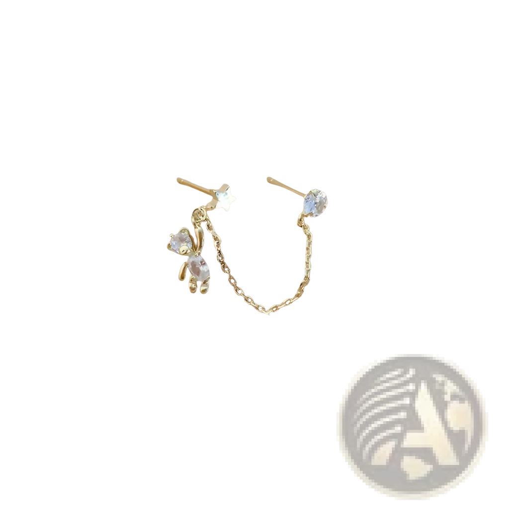 Gold-toned asymmetrical ear cuff earrings with star stud and rhinestone bear charm connected by delicate chain