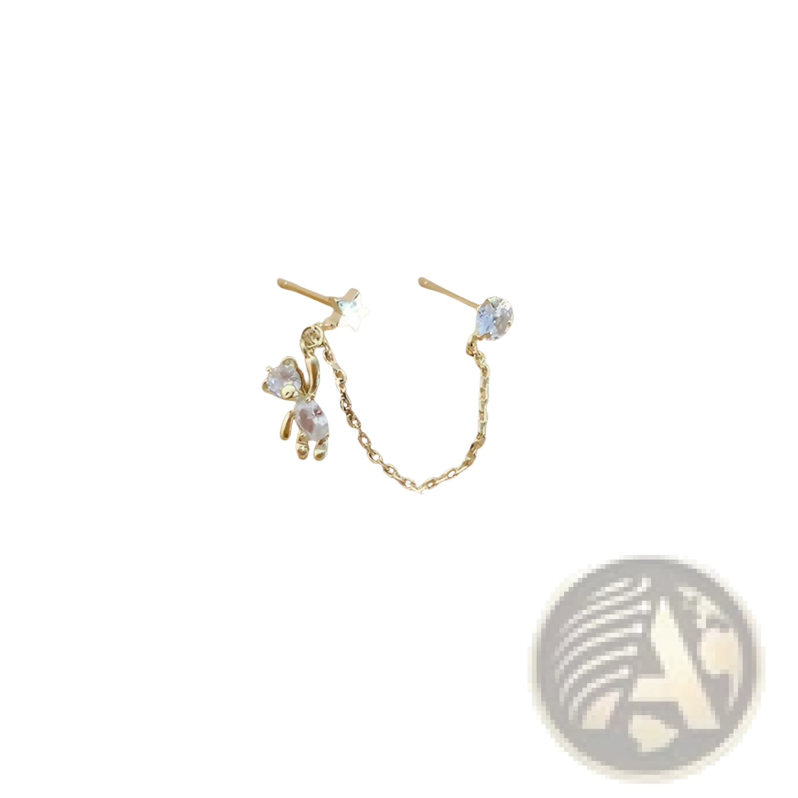 Gold-toned asymmetrical ear cuff earrings with star stud and rhinestone bear charm connected by delicate chain
