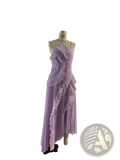 Lavender pleated asymmetrical chiffon dress with halter neckline displayed on mannequin for evening wear