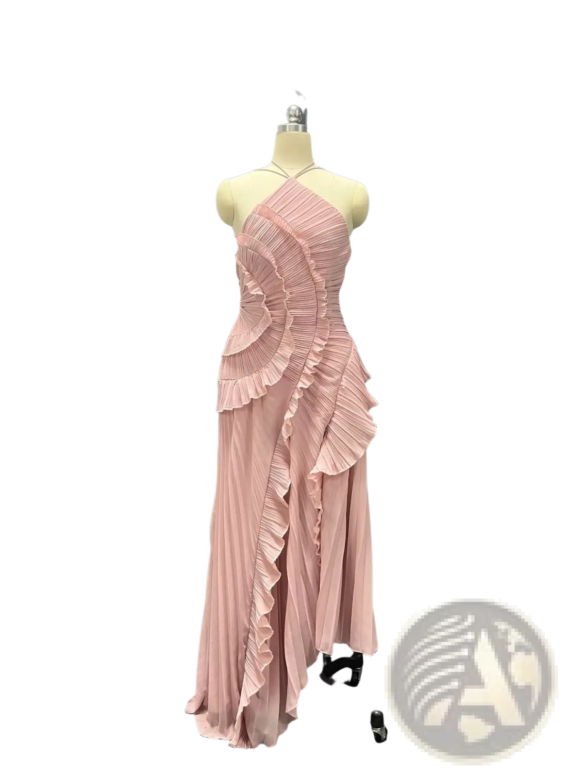 A flowing blush pink pleated chiffon evening dress with asymmetrical layered ruffles displayed on a mannequin