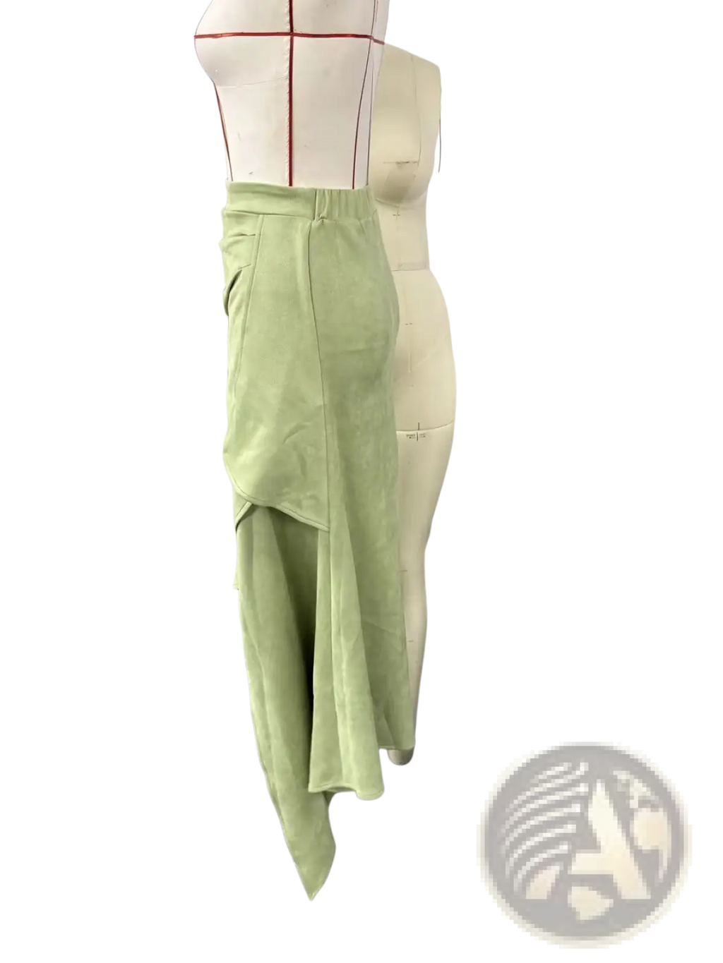 A light green asymmetrical ruffled skirt with layered suede and velvet fabric draping in a high-waisted design