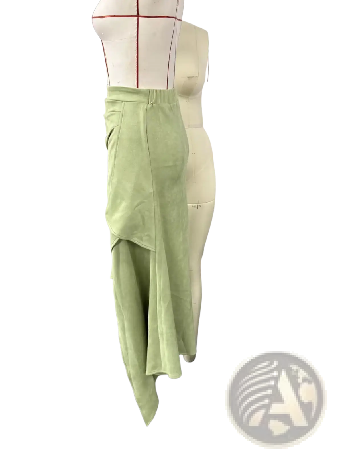 A light green asymmetrical ruffled skirt with layered suede and velvet fabric draping in a high-waisted design
