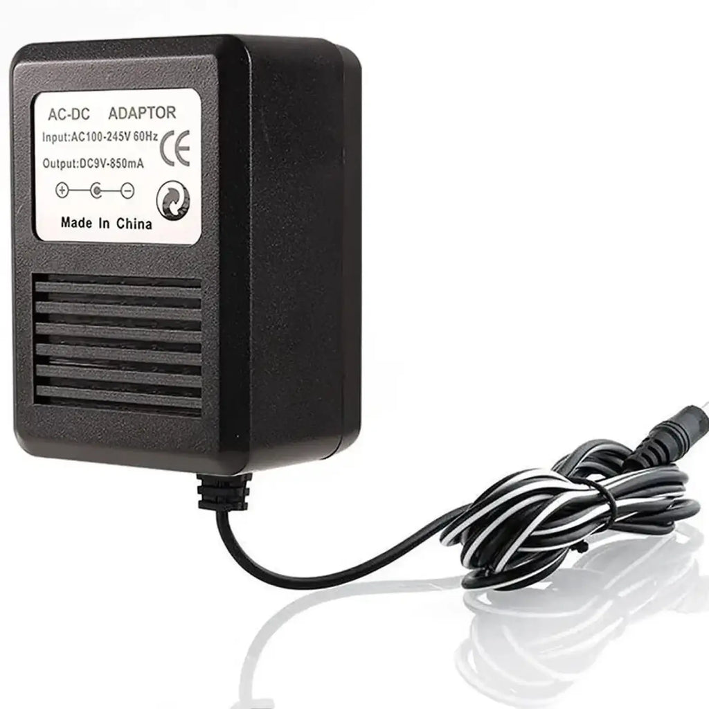 Black plastic Atari 2600 replacement ac-dc power supply with coiled black and white cable for US plug use