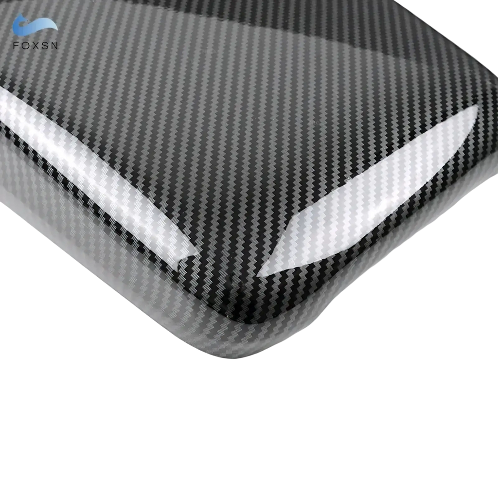 Black carbon fiber textured audi a4 b9 a5 console armrest cover with glossy white accent stripes visible on back side
