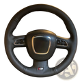 Audi leather steering wheel cover with red stitching on black perforated leather steering wheel with silver trim and buttons