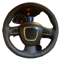 Black perforated leather Audi steering wheel cover with red stitching silver accent center and integrated control buttons