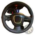 Black perforated leather Audi steering wheel cover with red stitching silver accent center and integrated control buttons