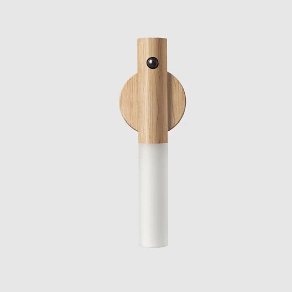 Minimalist magnetic wooden motion sensor led night light with a light oak wood base and frosted white glass shade