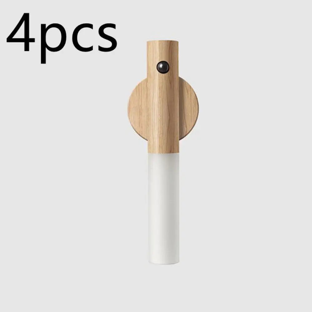 Minimalist magnetic wooden motion sensor led night light in white with a cylindrical design and circular wood base