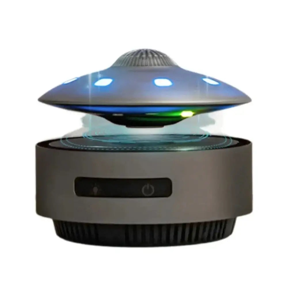 A sleek metallic gray floating ufo magnetic levitation Bluetooth speaker with glowing blue LED lights on its dome