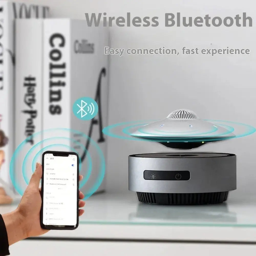 Silver and black wireless bluetooth speaker with sleek floating ufo design featuring magnetic levitation and led lights