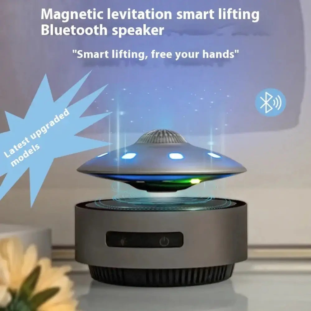 Silver ufo-shaped magnetic levitation bluetooth speaker with glowing blue and green led lights floating design
