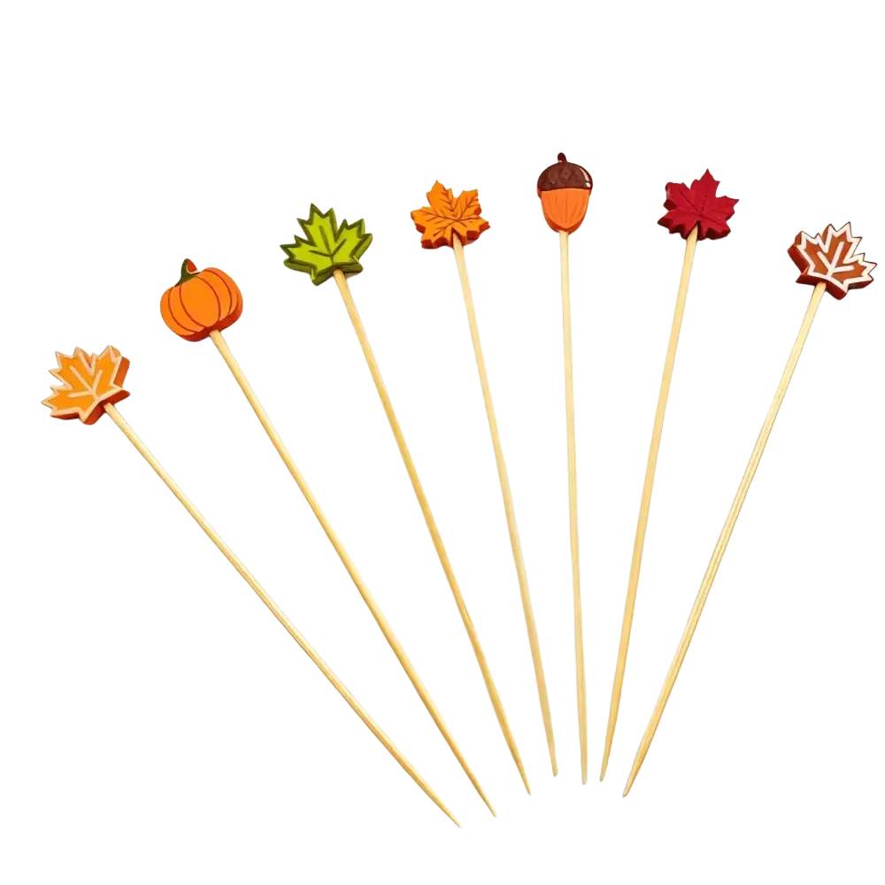 Set of six autumn bamboo food skewers topped with colorful wooden cutouts of pumpkins leaves and acorns