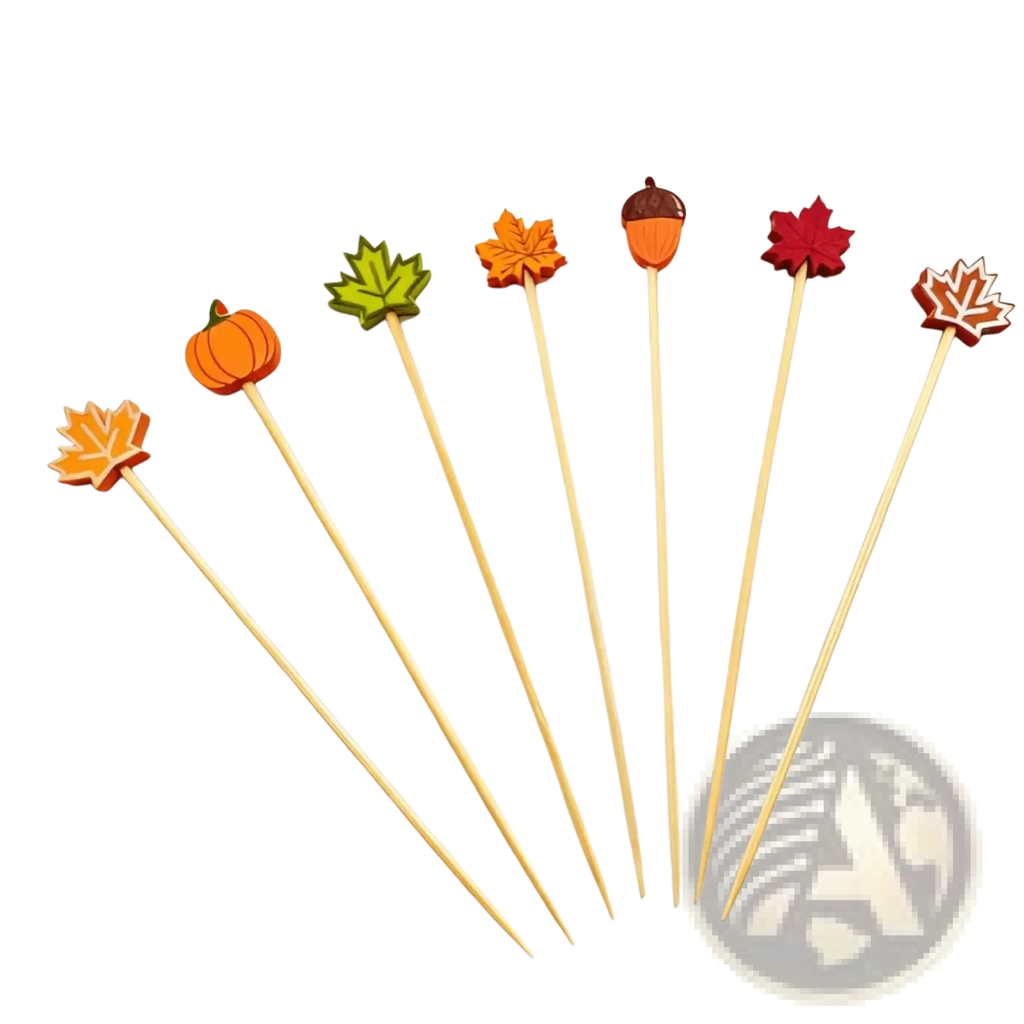 Set of six autumn bamboo food skewers topped with colorful wooden cutouts of pumpkins leaves and acorns