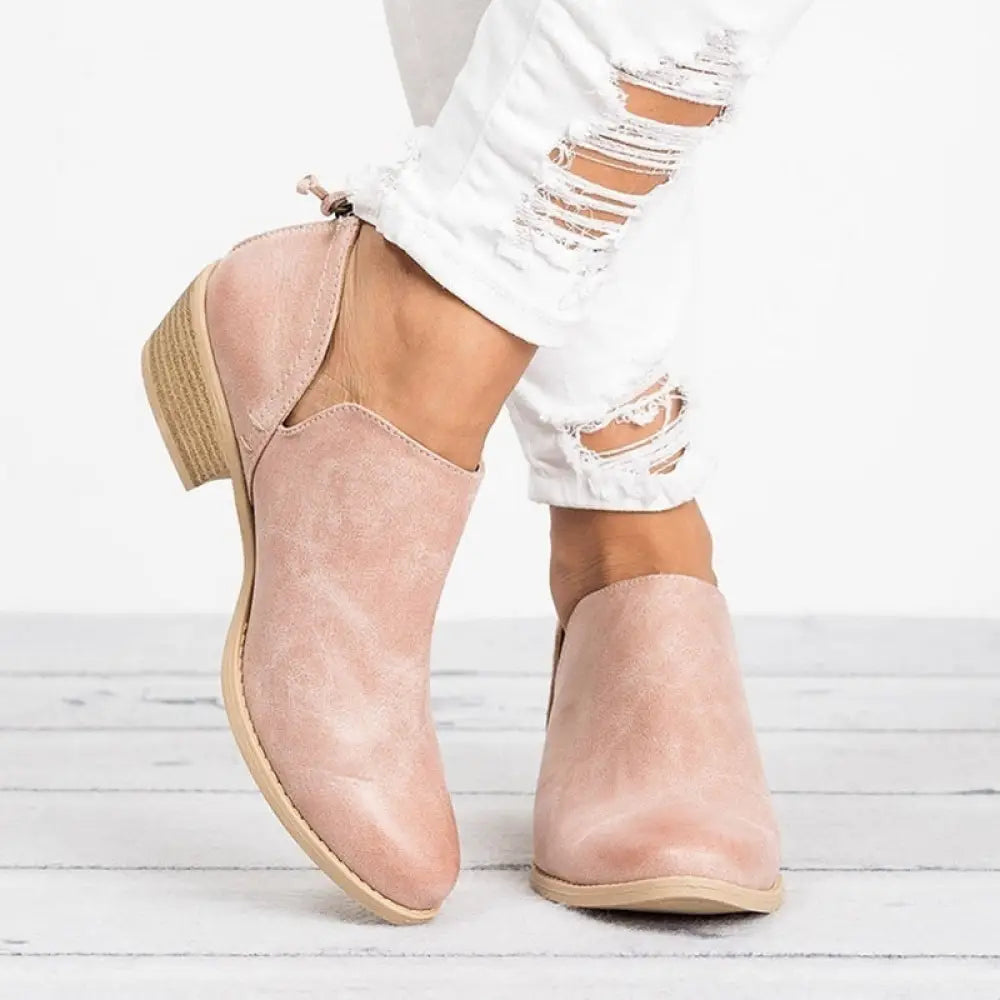 Retro suede low block heel ankle boots in pink suede shown from the back with a zipper pull detail
