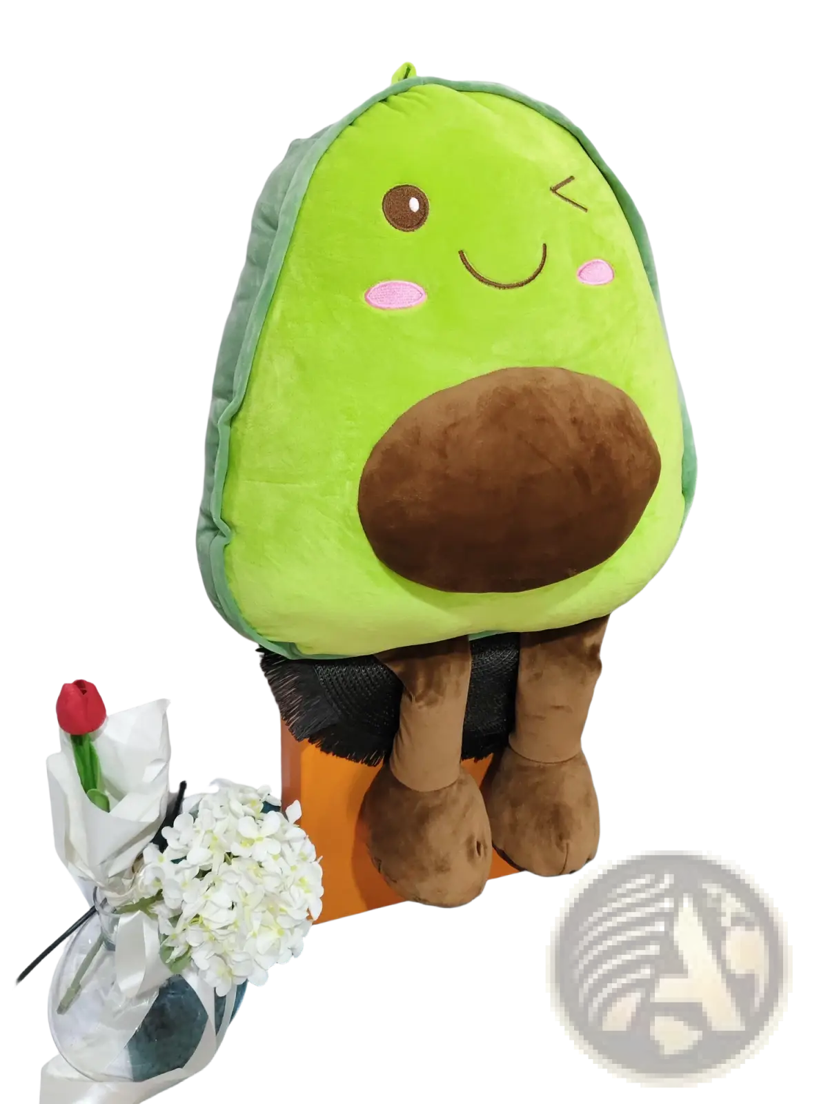 A plush avocado-shaped pillow with a soft green body brown pit and embroidered facial features for kids