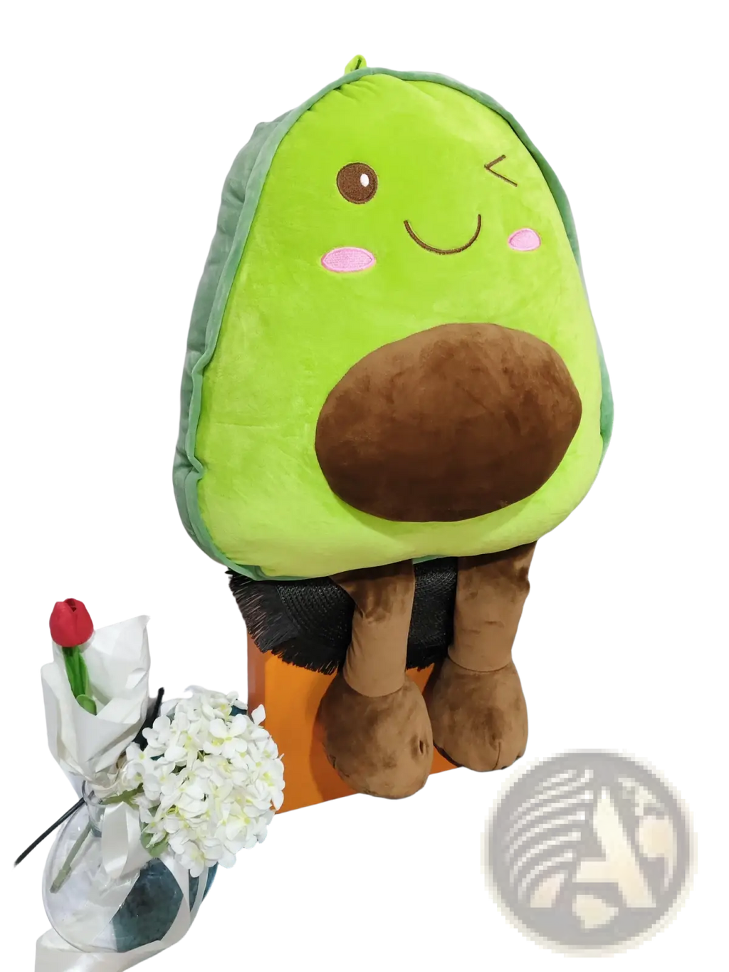 A plush avocado-shaped pillow with a soft green body brown pit and embroidered facial features for kids