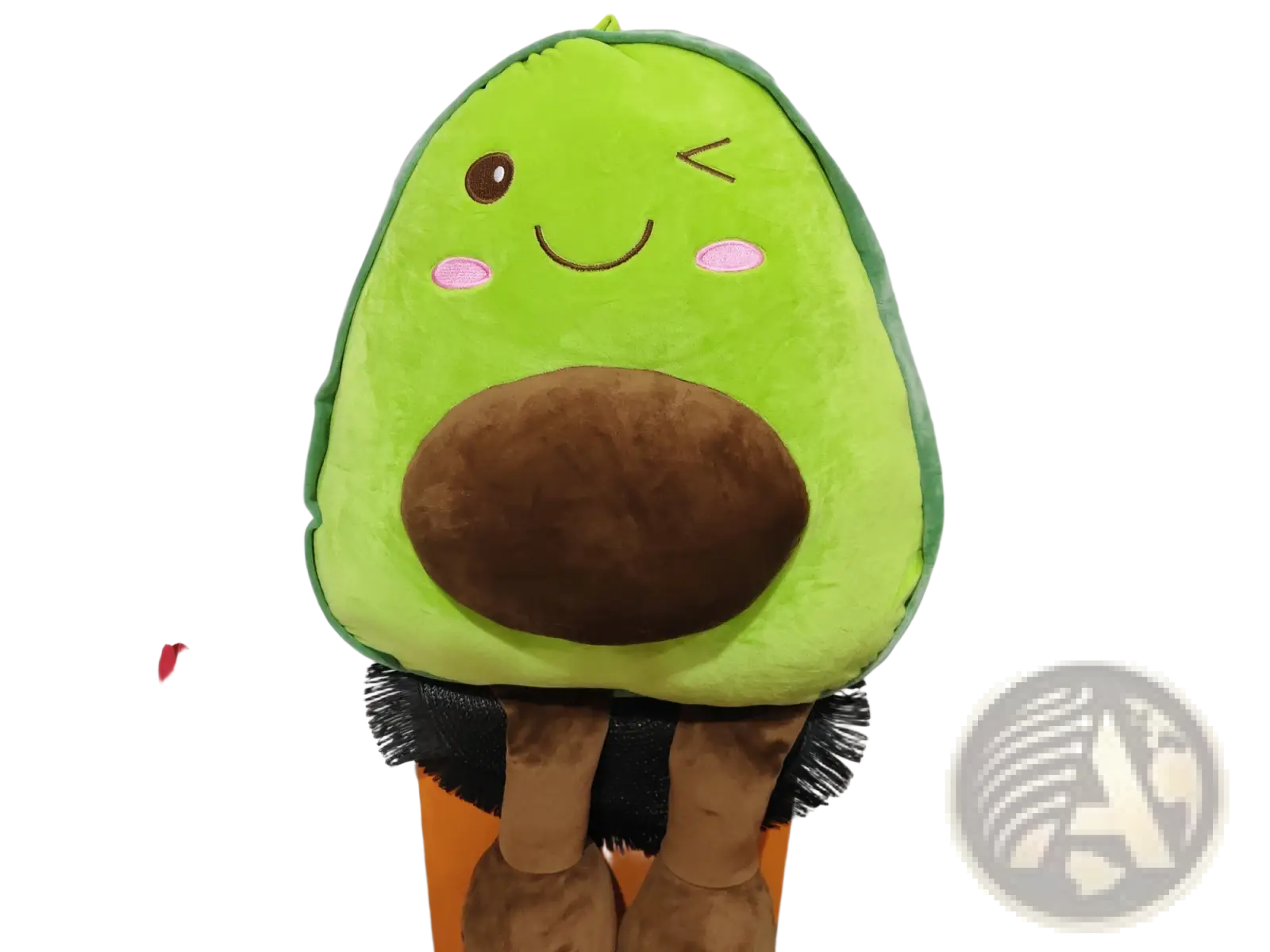 A soft plush avocado toy pillow with green body brown pit and embroidered facial features for kids