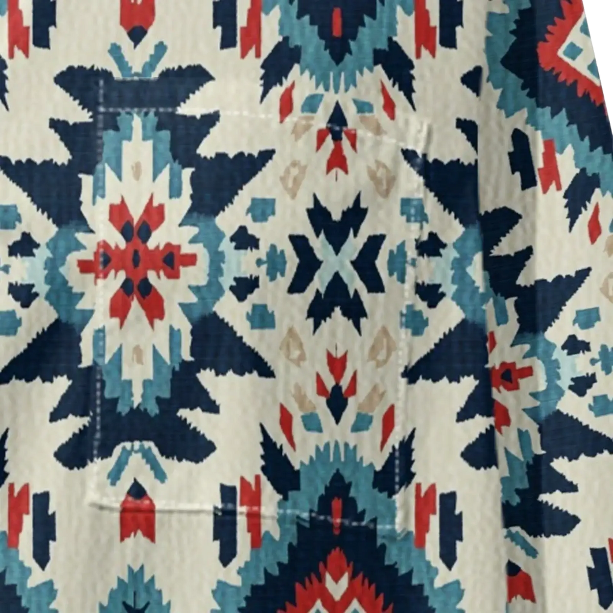 A cream-colored cotton aztec geometric button up women shirt with bold navy blue red and teal tribal patterns