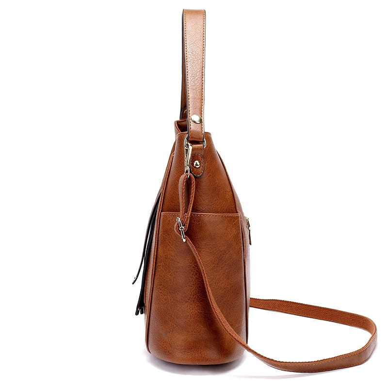 Brown leather hobo bag with tassel and front zipper pockets featuring faux leather material, a top handle, and detachable shoulder strap.
