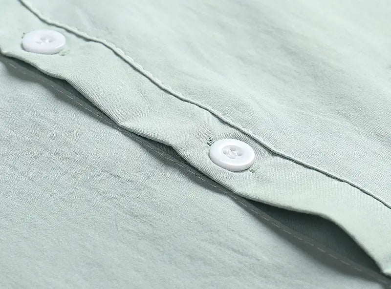 Men’s casual short sleeve linen blend summer shirt in light green with white plastic buttons.