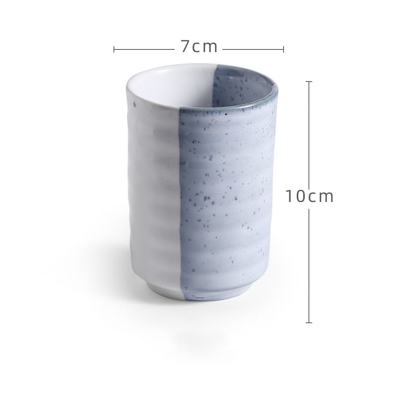 A Japanese ceramic mug with a retro hand-painted design featuring a speckled white and gray glaze finish divided vertically by a clean line used as a tea cup with a 250ml capacity.