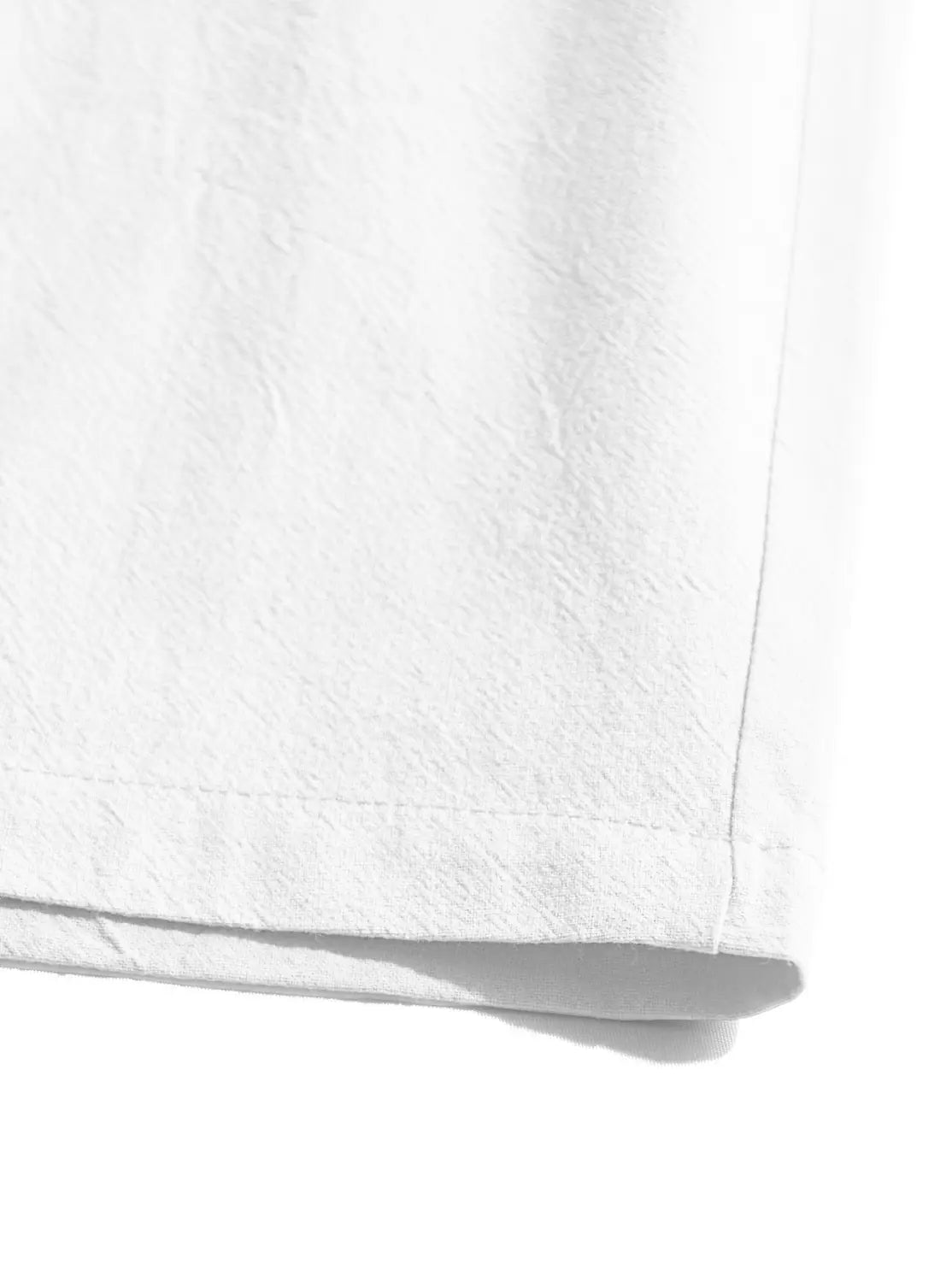 White cotton linen drawstring shorts featuring white cotton fabric with a subtle textured weave and a neatly stitched hem.