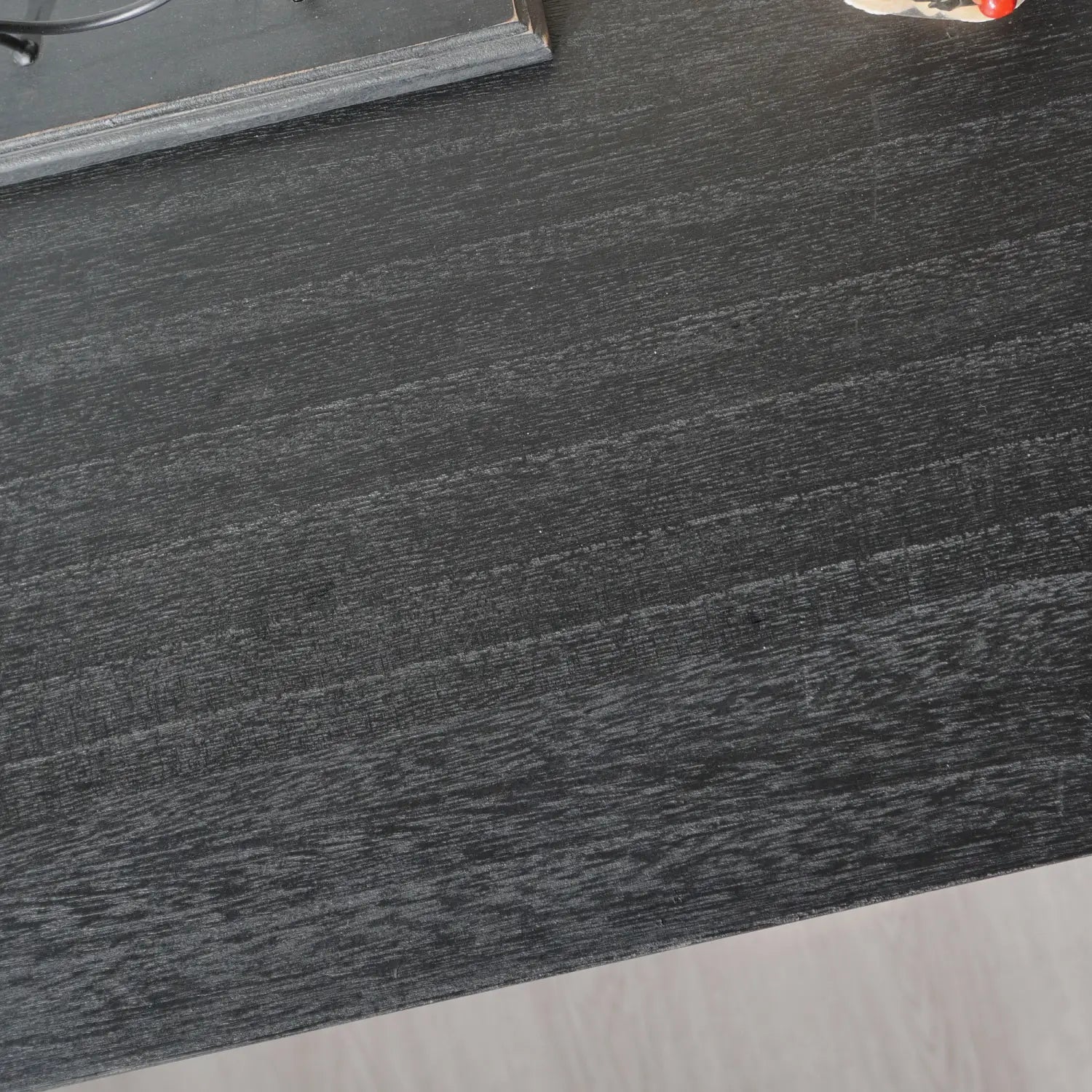 dark gray wood-grain laminate tabletop with subtle horizontal grain texture on black wood storage cabinet 31in arched accent cabinet