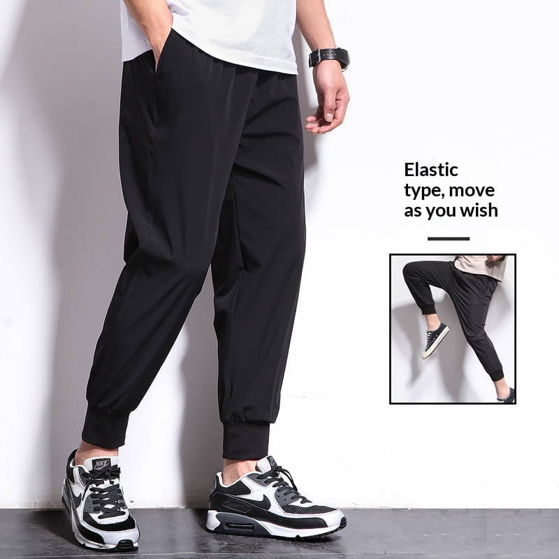 Pantalon de jogging athlétique pour hommes grande taille en noir, en tissu élastique, avec coupe décontractée et poignets fuselés.