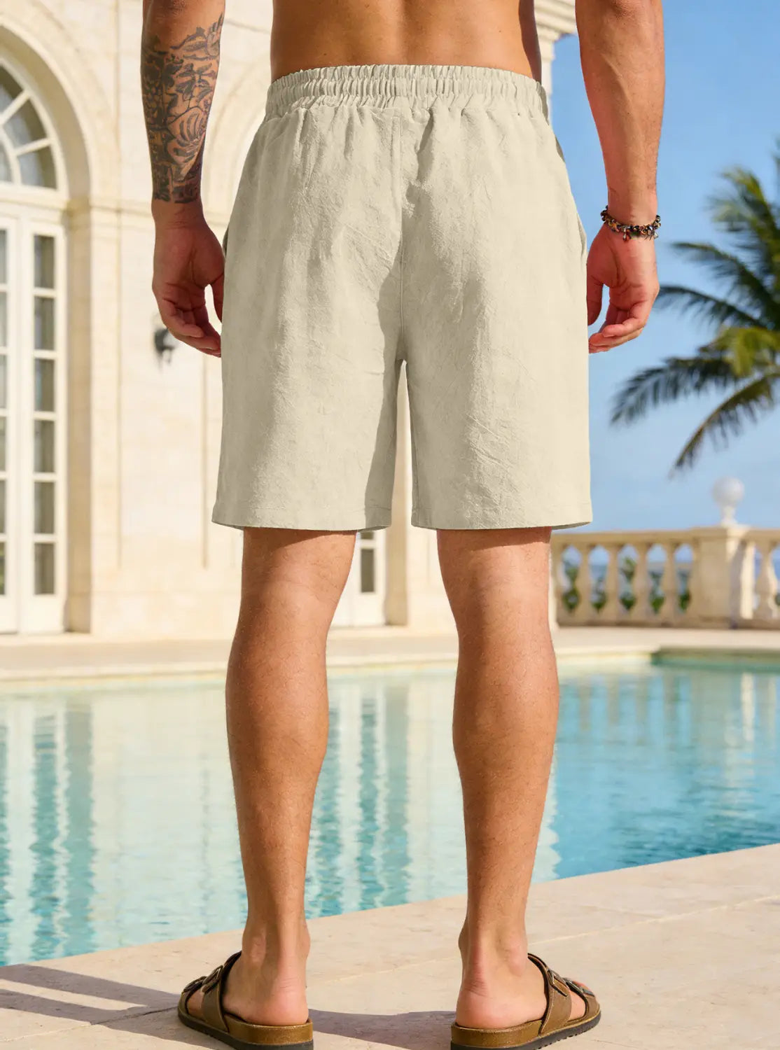 Beige cotton linen drawstring shorts for men featuring an elastic waistband for comfort.