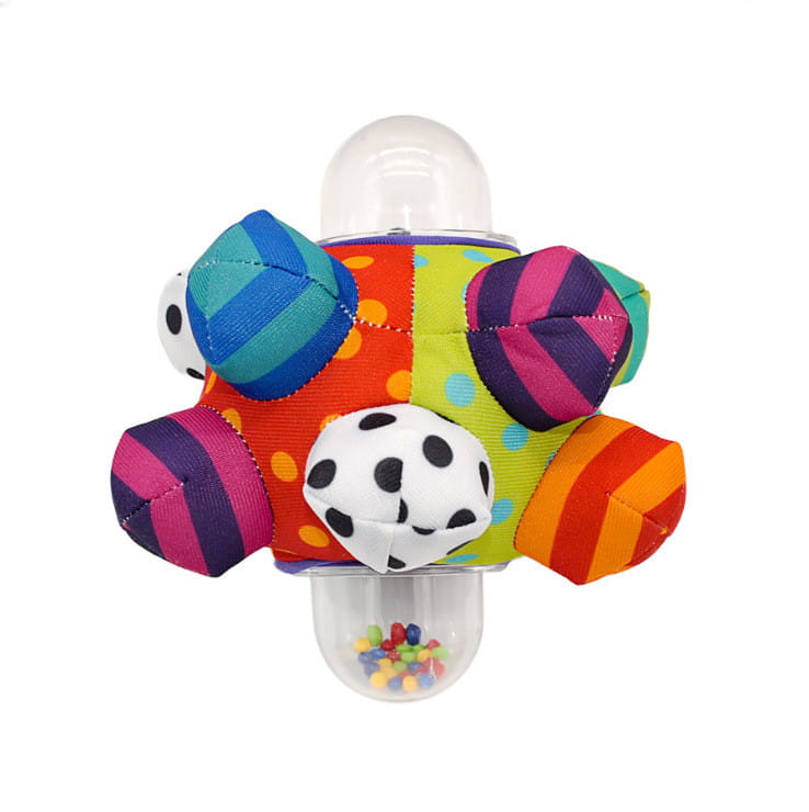 plush baby rattle ball grasping toy with colorful striped and polka dotted fabric sections and a clear plastic base filled with colorful beads for sensory play.