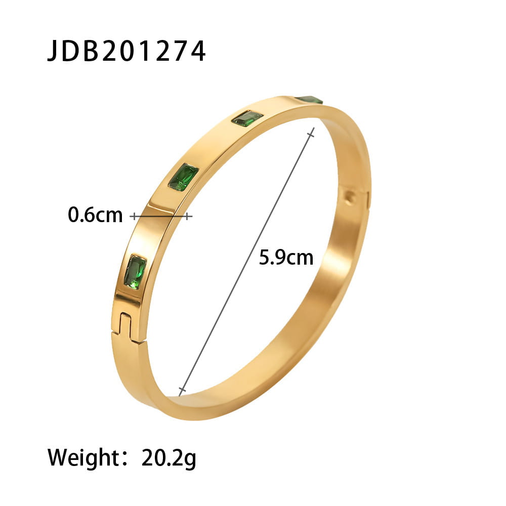 Gold plated stainless steel bangle bracelet featuring three rectangular green zirconia gemstones on a gold-toned surface.