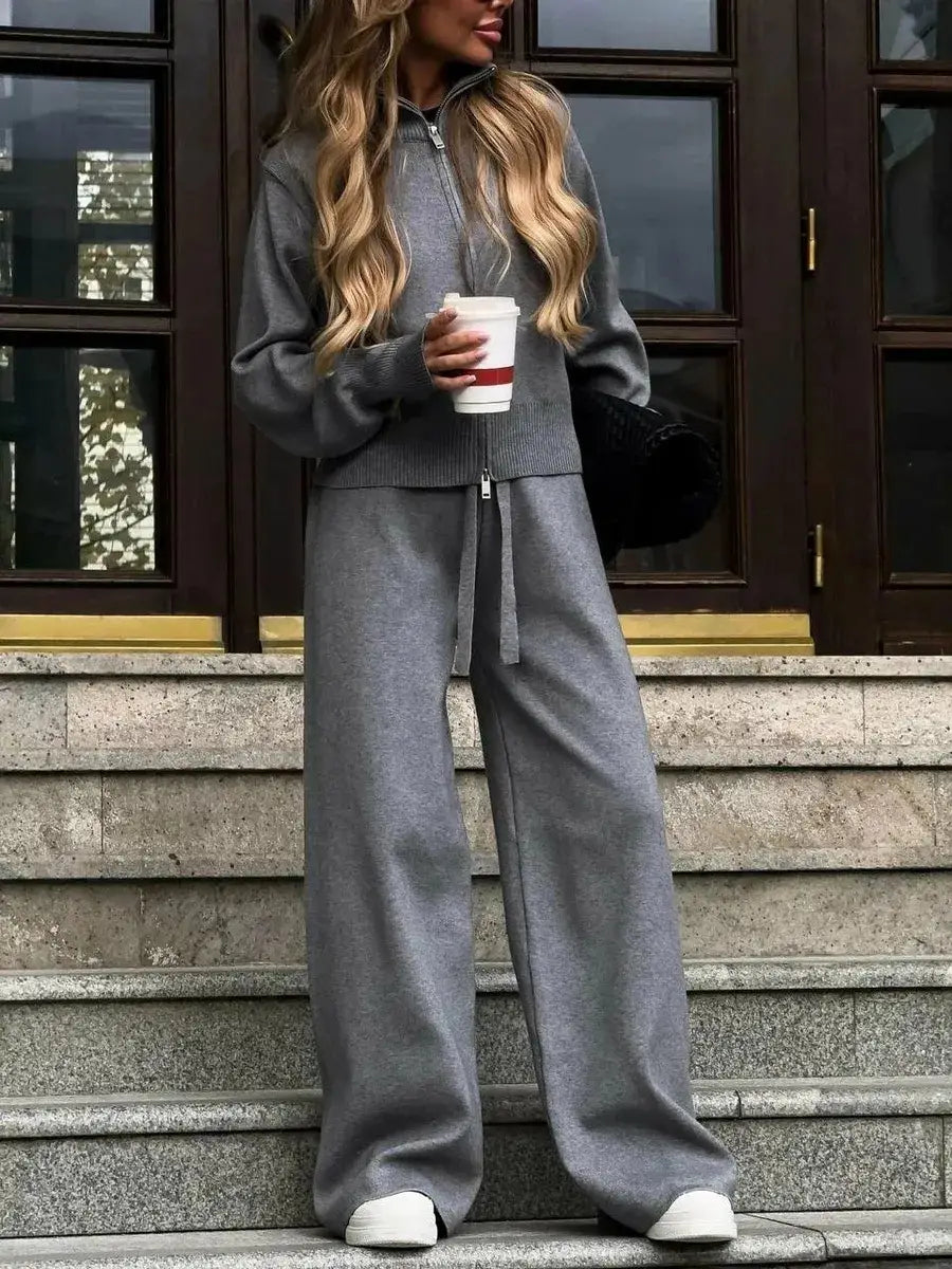 woman wearing a gray knit two-piece sweatsuit consisting of a zip-up hoodie cardigan and wide-leg pants