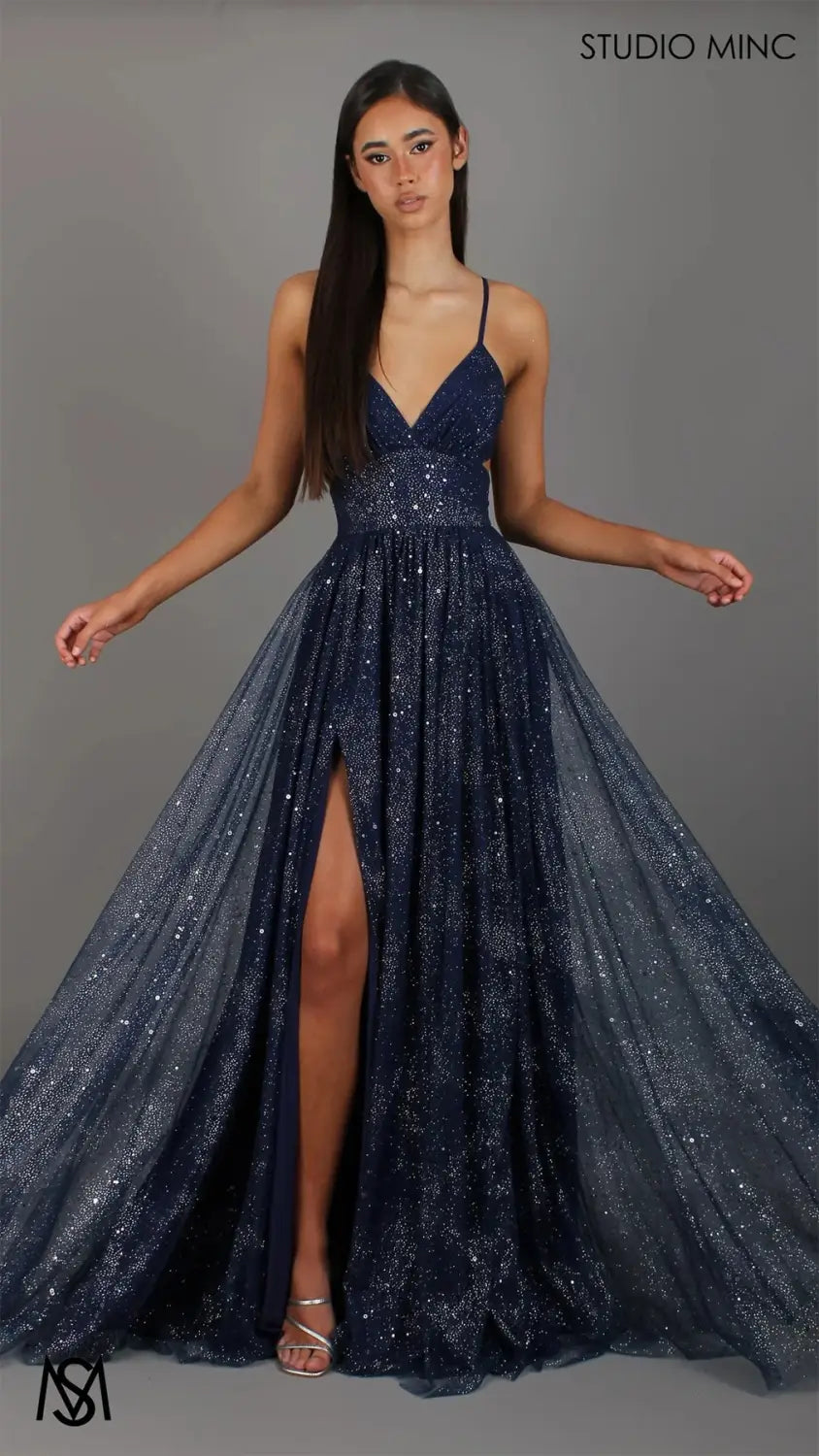 A navy blue sequined shimmering v neck high slit maxi evening gown with delicate spaghetti straps.