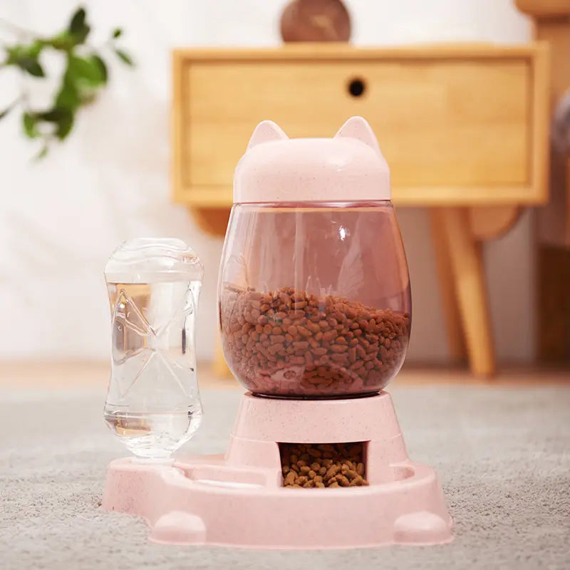 automatic cat feeder and water fountain featuring a pink cat-shaped design with a transparent body and pink plastic base for convenient pet feeding.