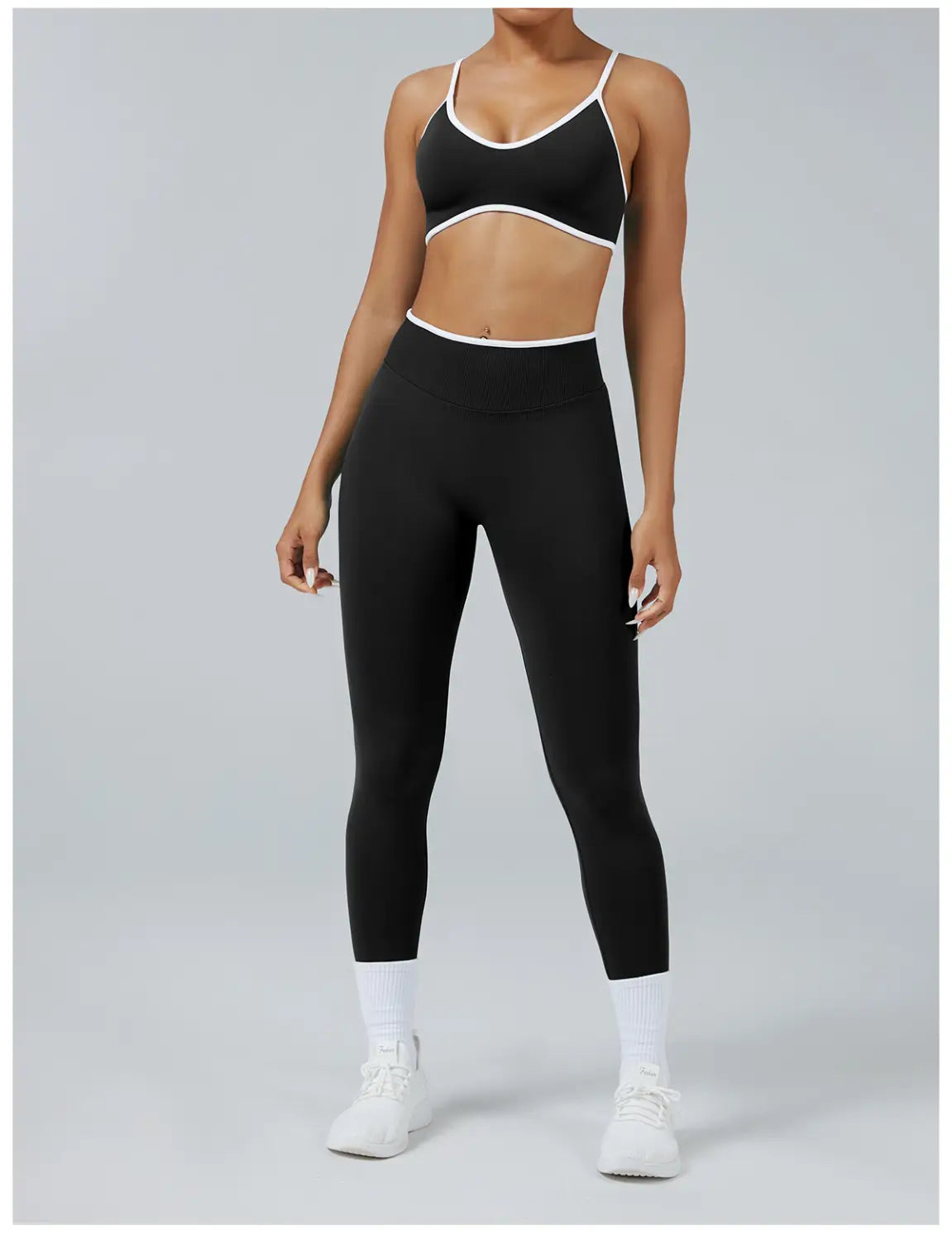 black and white seamless high waist sports yoga leggings and matching cropped bra top with thin straps made from stretch fabric designed for athletic use