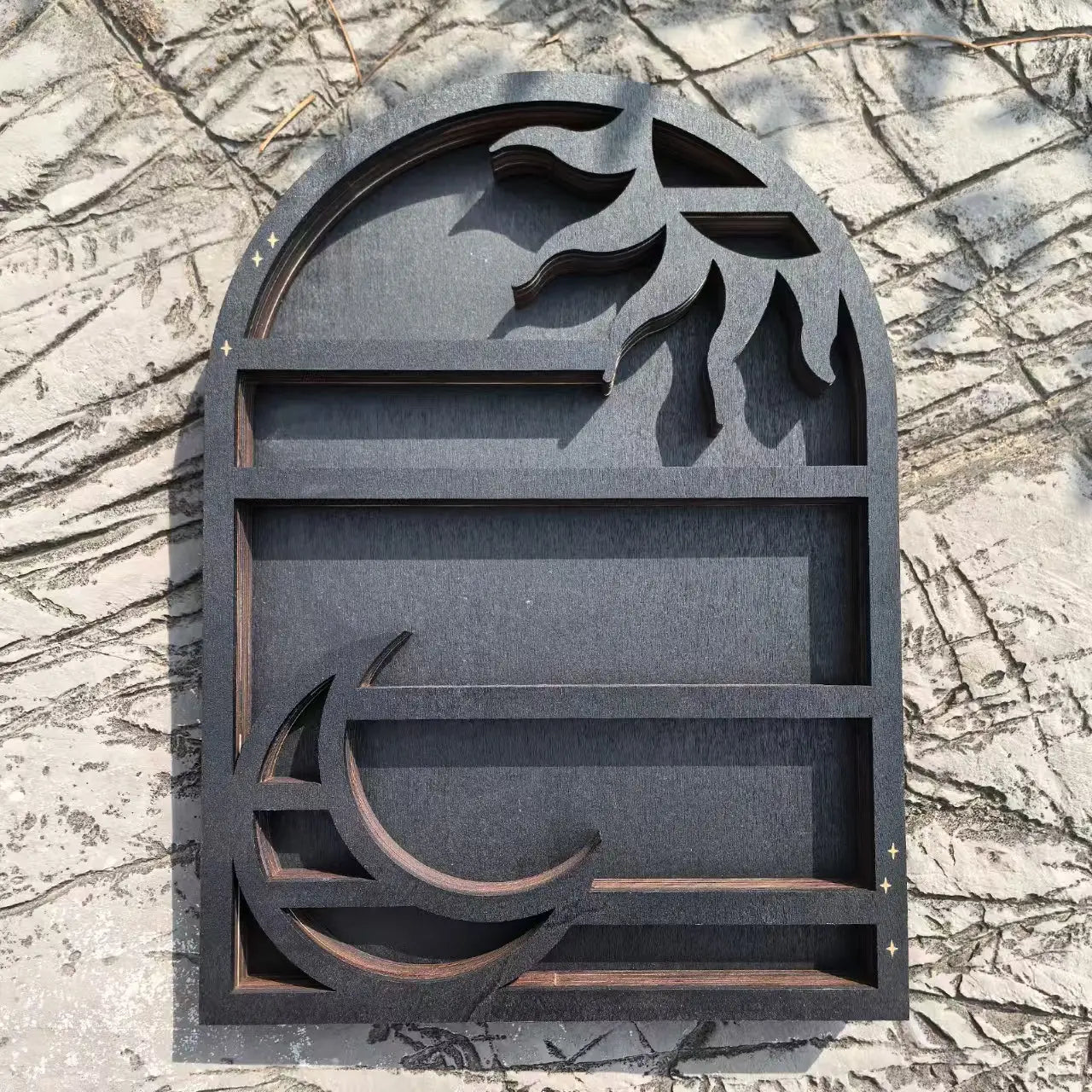 Dark gray arched wooden sun floating shelf with carved sun and moon motifs designed as a black wooden crystal display rack.