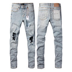 Men’s distressed slim fit patchwork denim jeans in light-wash denim with ripped knees and a slim fit cut.