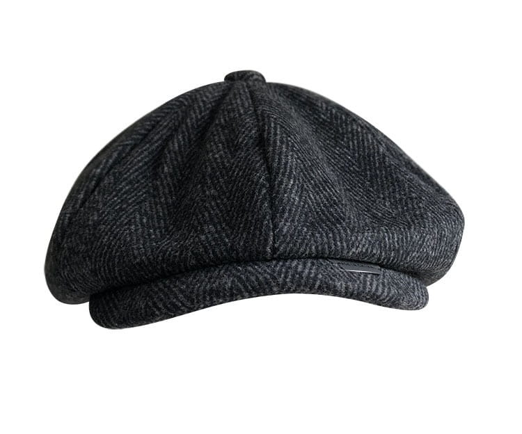 A dark gray herringbone-patterned woolen flat cap with a structured six-panel design and a slightly curved brim called herringbone woolen octagonal flat cap.
