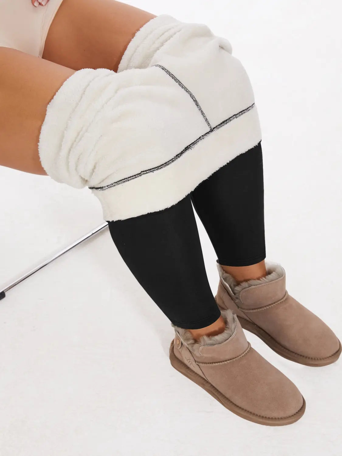 Cream-colored suede ugg-style boots with plush shearling lining paired with fleece lined high waisted winter leggings.
