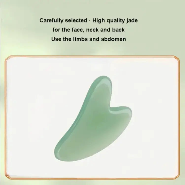 A smooth translucent light green jade gua sha tool made of natural resin with a curved heart-shaped design for facial massage.
