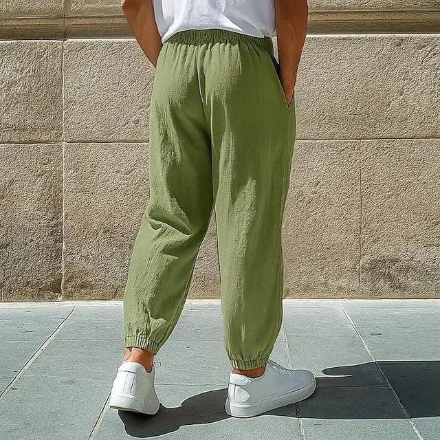 olive green cotton joggers with elastic cuffs and side pockets designed as men cotton cargo pants solid color casual work trousers.