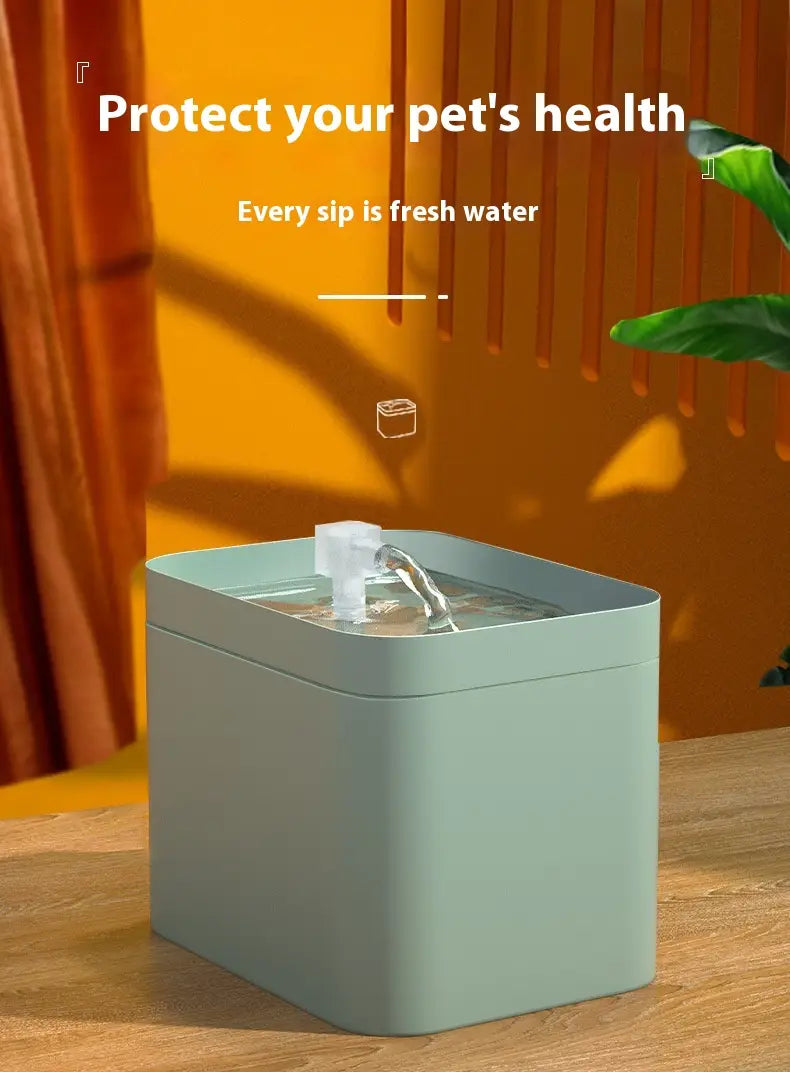 Light green rectangular automatic cat water fountain with a clear plastic spout and flowing stream of fresh water for 1500ml circulation.
