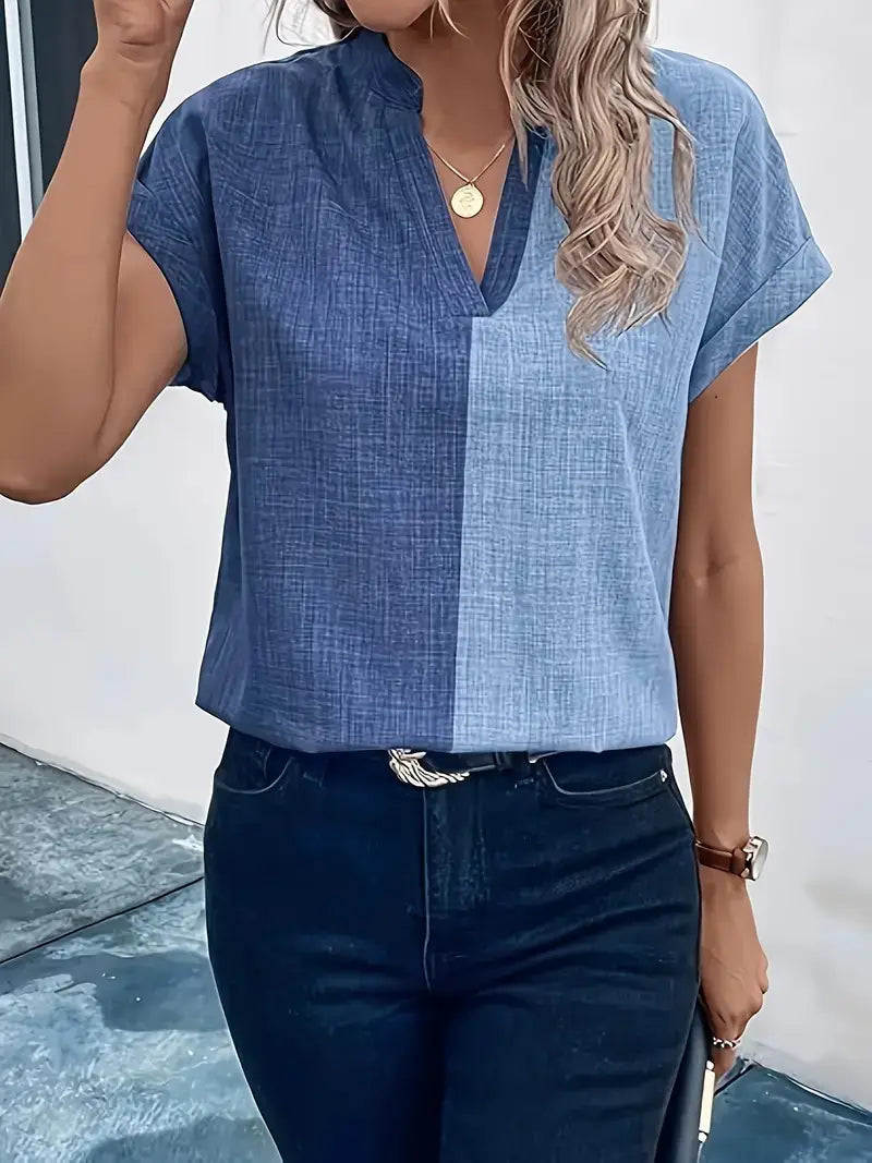Blue denim-like short-sleeved abstract print v-neck stretch satin blouse with a contrasting light blue panel down the front.